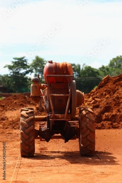 Fototapeta Laterite cutting machine in the mining field.laterite is a soil and rock type rich in iron and aluminium and is commonly considered.it is a red stone for building constructions in kerala