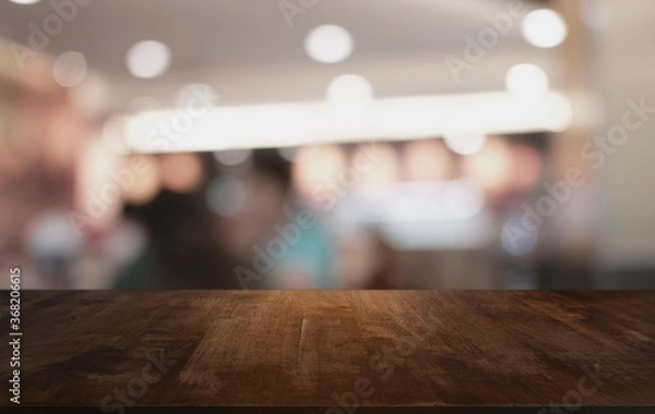 Fototapeta Wood Table Top in Blur Background room interior with empty copy space.