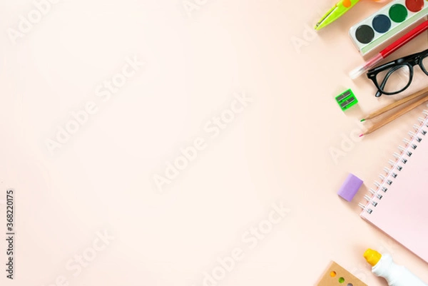 Fototapeta Top view of modern bright blue office desktop with school supplies on table around empty space for text. Back to school concept.