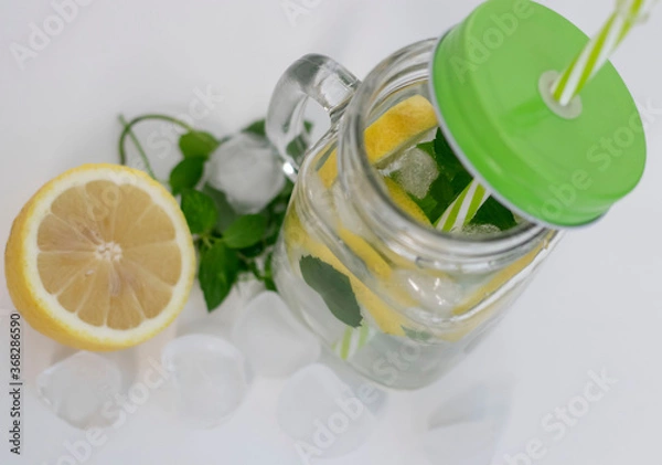 Fototapeta 
Drink with lemon, mint and ice. All this on a white background