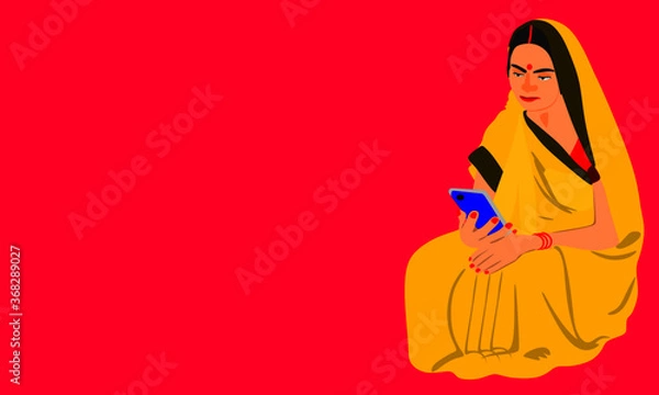 Obraz An indian village lady operating smart phone wearing yellow traditional sari at pink background.