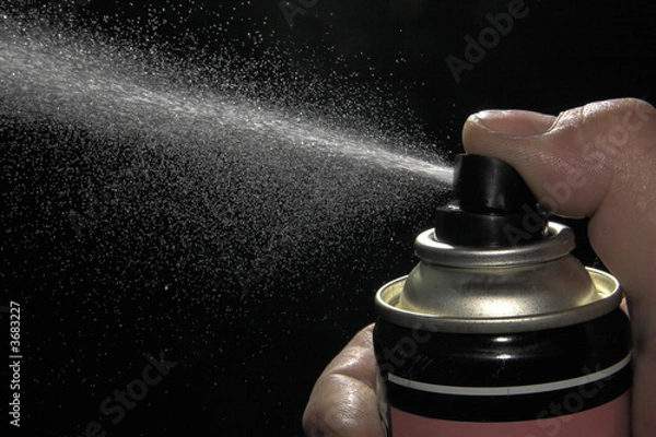 Obraz Pulverizing liquid with spray can
