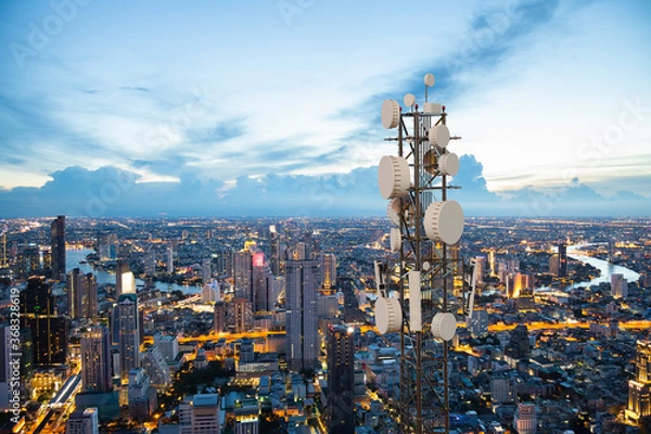 Fototapeta Telecommunication tower with 5G cellular network antenna on night city background