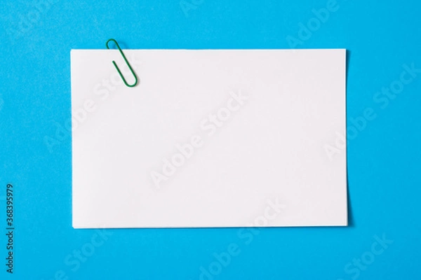 Obraz white sheet of paper for notes and paper clip
