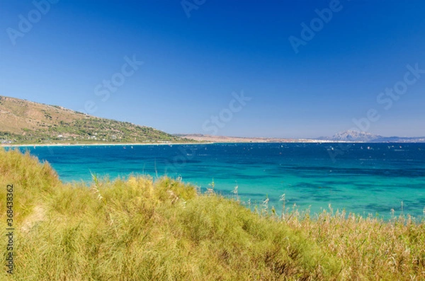 Fototapeta Beautiful seascape with blue sky and Atlantic ocean. Morocco and mount Jebel Musa on the background. Punta Paloma beach, Tarifa, Provence of Cadiz, Spain. 