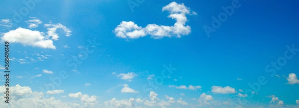 Fototapeta Blue sky background with clouds. Wide photo.