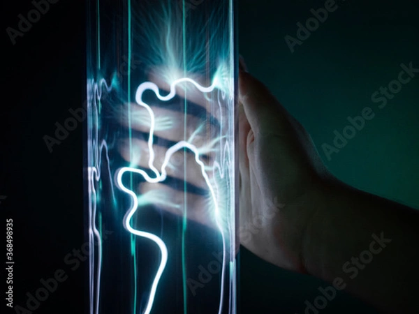 Obraz A child's hand touches a flask with current.