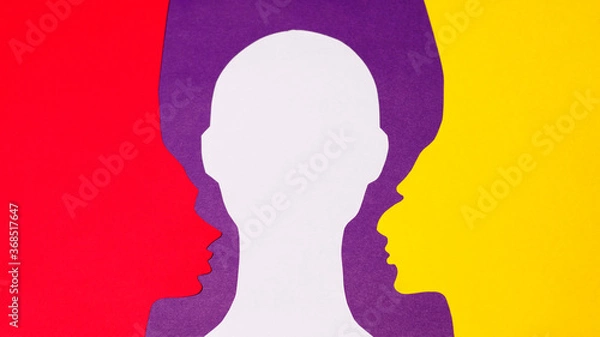 Fototapeta The paper profiles and paper full-face were cut out from yellow, red, purple, and white paper. The photo of handmade paper art was shot flat lay for your craft design.