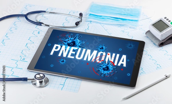 Fototapeta Tablet pc and doctor tools on white surface with PNEUMONIA inscription, pandemic concept