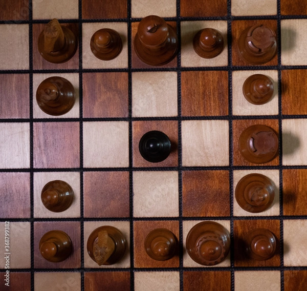 Obraz top down view of black pawn surrounded