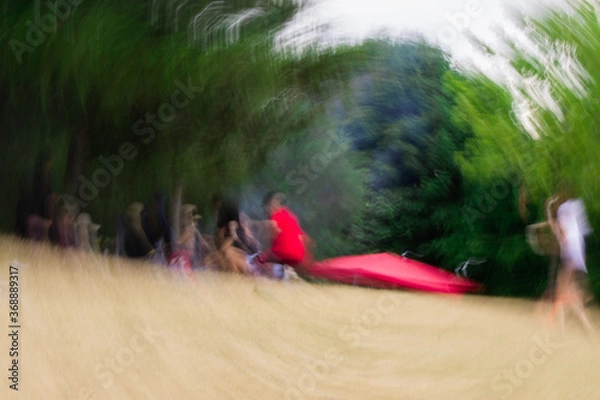 Fototapeta Bright photo with blurred view of group of people.