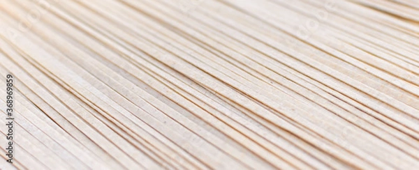 Obraz Brown soba noodles close up, top view. Asian cuisine, buckwheat pasta, raw, uncooked, natural, organic, vegetarian healthy food background. Striped surface. Banner with copy space.