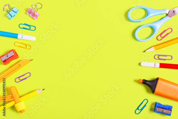 Fototapeta Different school supplies on an yellow background. Back to school concept. Concept for a store of goods for study and stationery. Copy space, flat lay, top view.