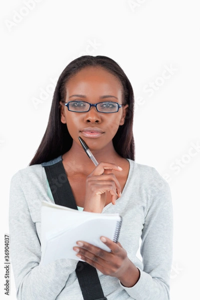 Fototapeta Young woman with notepad and glasses