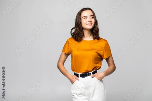 Obraz Portrait of beautiful young woman standing on grey background