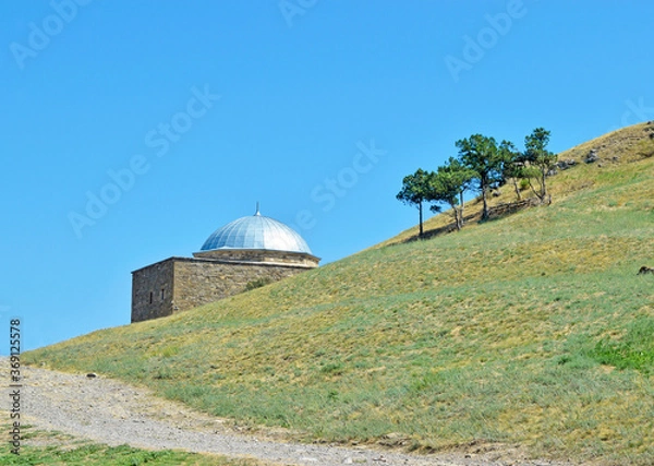 Fototapeta View of the ancient temple on the slope.