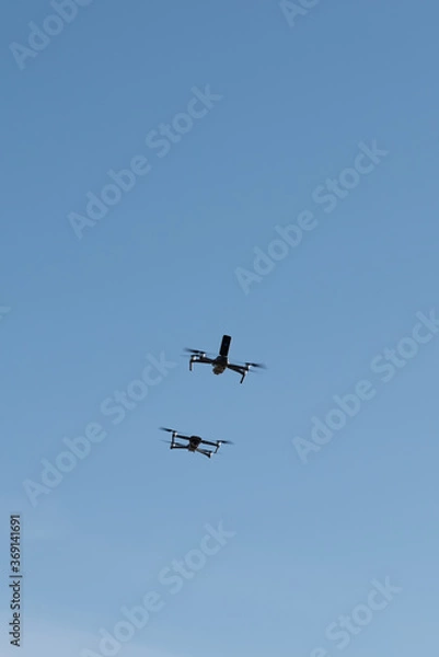Obraz Two drones racing in the sky.