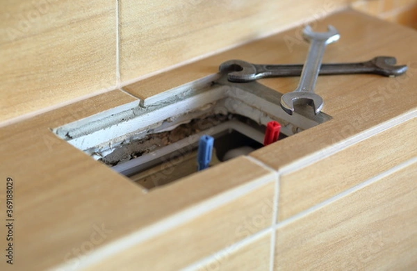 Fototapeta Broken mechanism of modern toilet cistern, open toilet cistern and two metal spanners / wrenchs close up