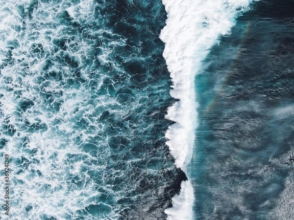 Fototapeta Ocean with waves and a rainbow in Indonesia, magical blue surface