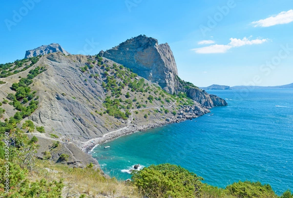 Fototapeta View of a high cliff and a turquoise sea in summer