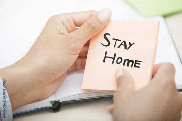 Obraz Hands holding pink sticky note with Stay Home text