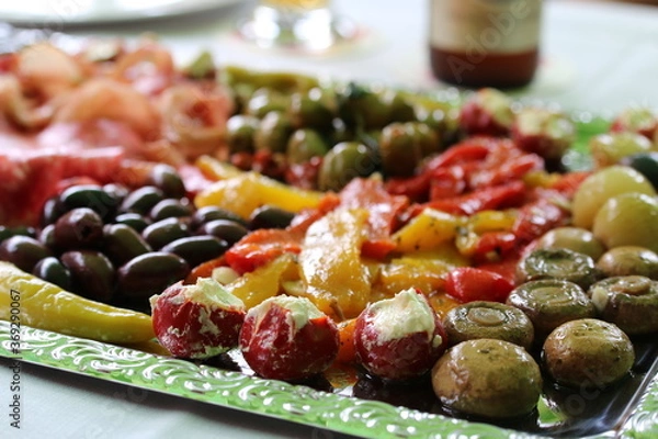 Obraz Various antipasti on a silver-colored tray on a table