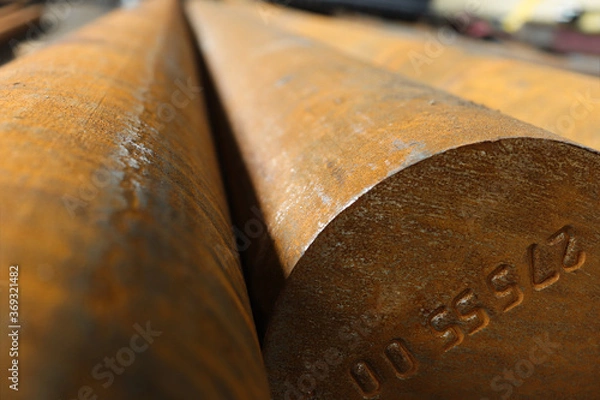 Fototapeta Large diameter steel bar manufactured at a metal rolling plant.