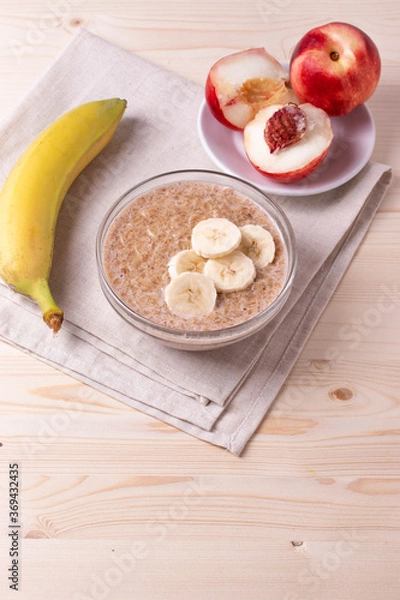 Fototapeta a portion of morning granola porridge served on rustic wooden surface