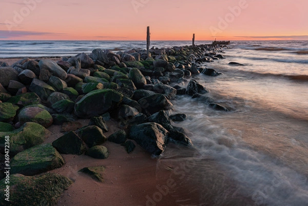 Obraz rock pier at sunset with waves