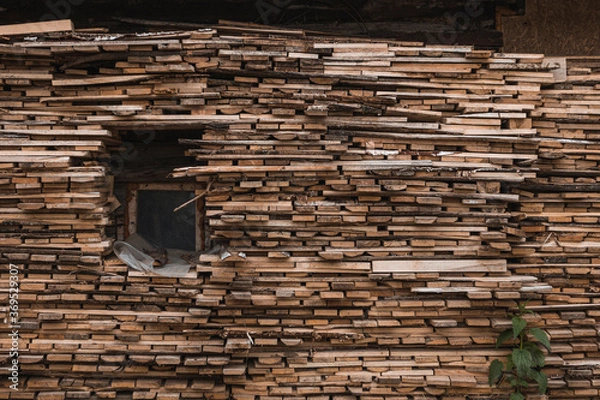 Fototapeta High woodpile, consisting of many stacked rows of firewood