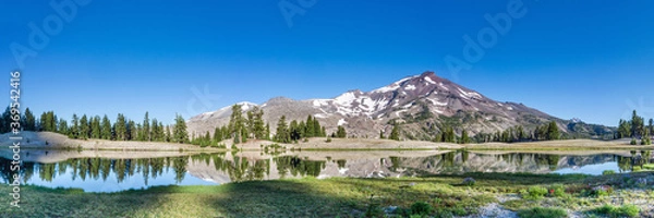 Obraz Mountain landscape with clear blue sky, morning light, reflective water, and a wide panoramic view.