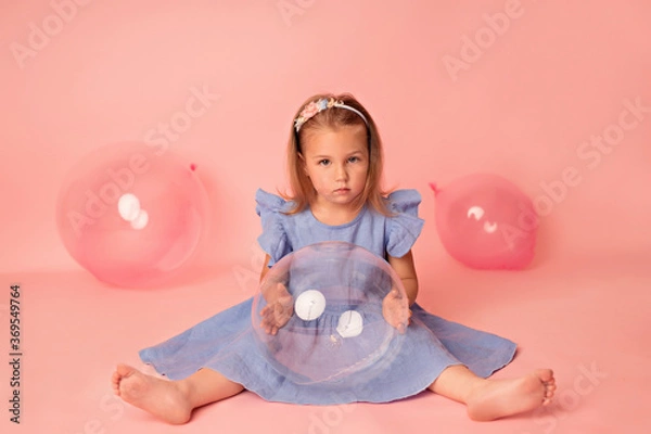 Obraz Happy baby girl on a pink background with balloons. Celebration. Birthday