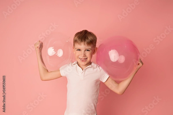 Obraz Happy baby boy on pink background with balloons. Celebration. birthday