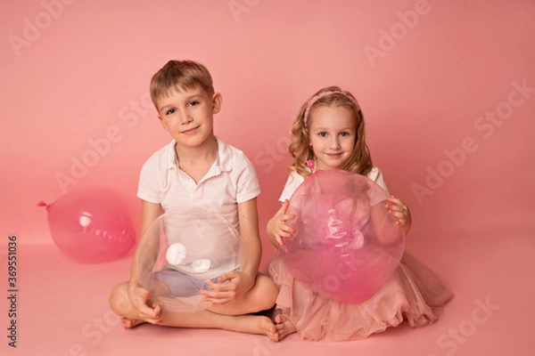Obraz Happy child girl and boy on a pink background with balloons. Celebration. birthday