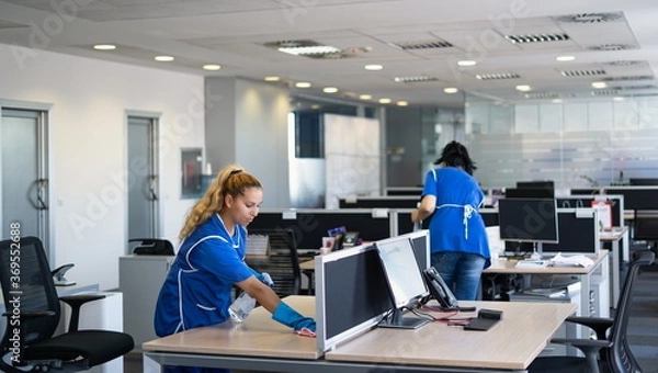 Fototapeta Cleaners clean empty office spaces