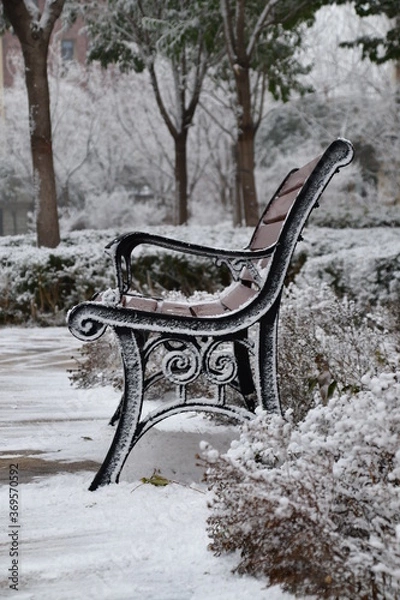 Obraz lonely bench covered with snow on christmas eve