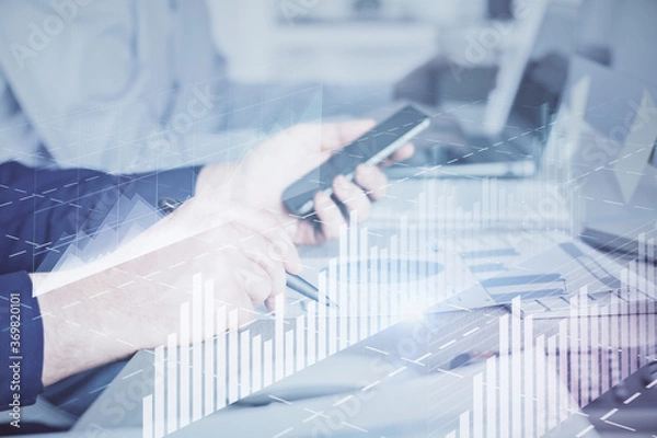 Fototapeta Double exposure of man's hands holding and using a digital device and forex graph drawing. Financial market concept.