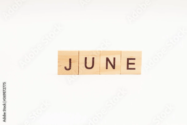 Fototapeta Word JUNE made of wooden blocks on white background. Month of year