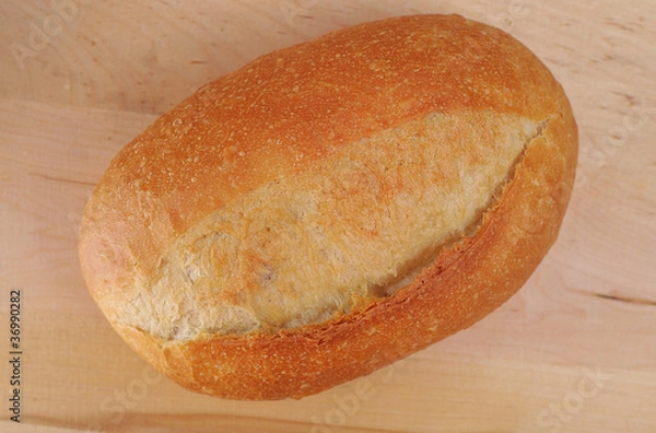 Obraz Bread and rolls on a cherry wood table