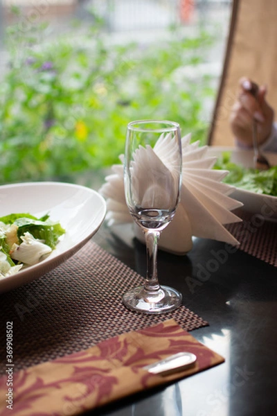 Obraz Just a wineglass standing on the table while dinner