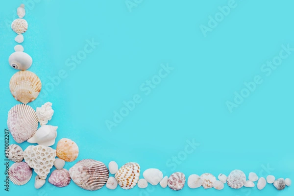 Fototapeta turquoise background with a corner of light seashells and white small stones