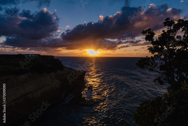Fototapeta sunset on the cliffs On the arch of Anguilla island in the Caribbean sea