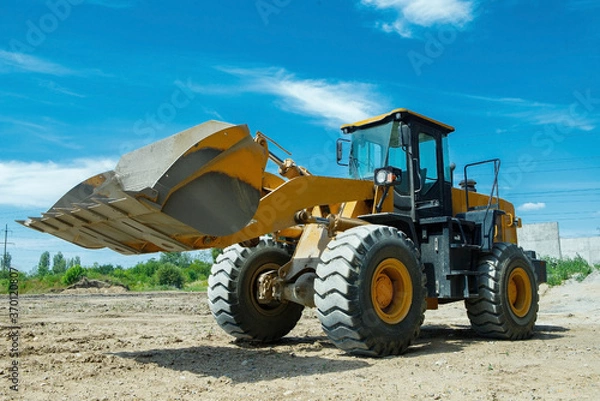 Obraz Wheel loader excavator at construction site
