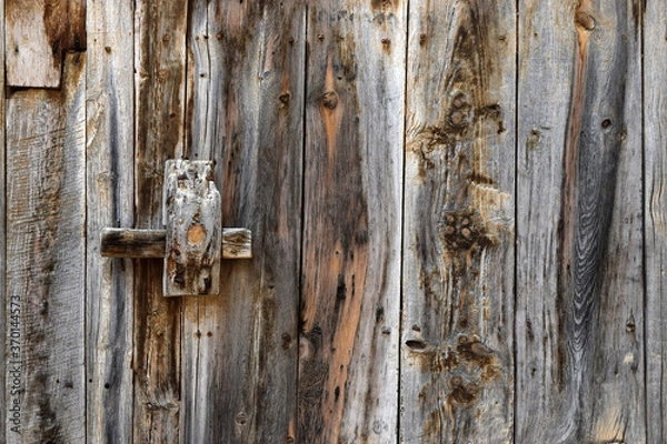 Fototapeta Rural style wood texture of an old door with crossbar closure