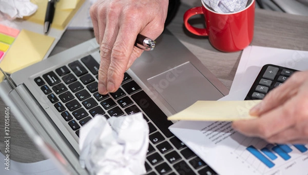 Obraz Businessman working on a messy desk