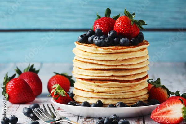 Obraz A stack if home-made pancakes with berry