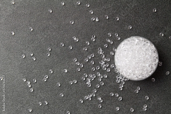 Fototapeta Transparent Polyethylene granules on a stone background .Plastic pellets. Plastic Raw material .HDPE. BPA FREE. Ad space