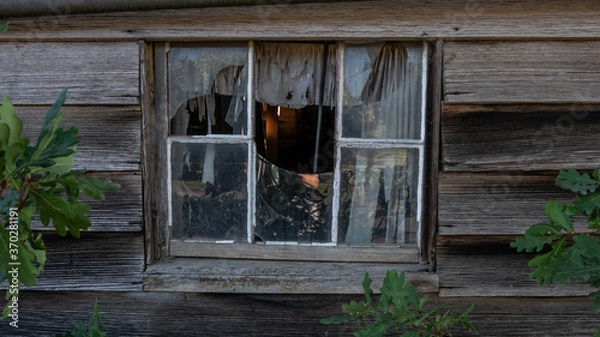 Fototapeta Broken window on an abandoned old house