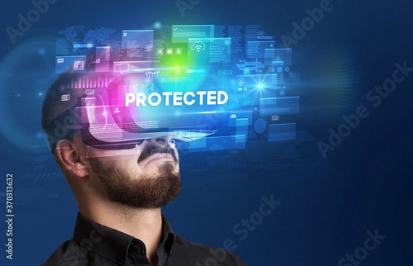 Fototapeta Businessman looking through Virtual Reality glasses with PROTECTED inscription, innovative security concept