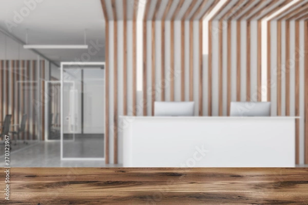 Fototapeta Table in blurry office with reception